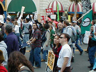 Floyce White distributes these flyers at February 15, 2003 peace march in Los Angeles.