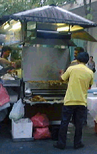 Man grilling satay