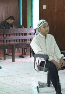 The defendant listening to the verdict