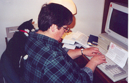 Sr. Kathleen and Benedict the Cat working at the computer