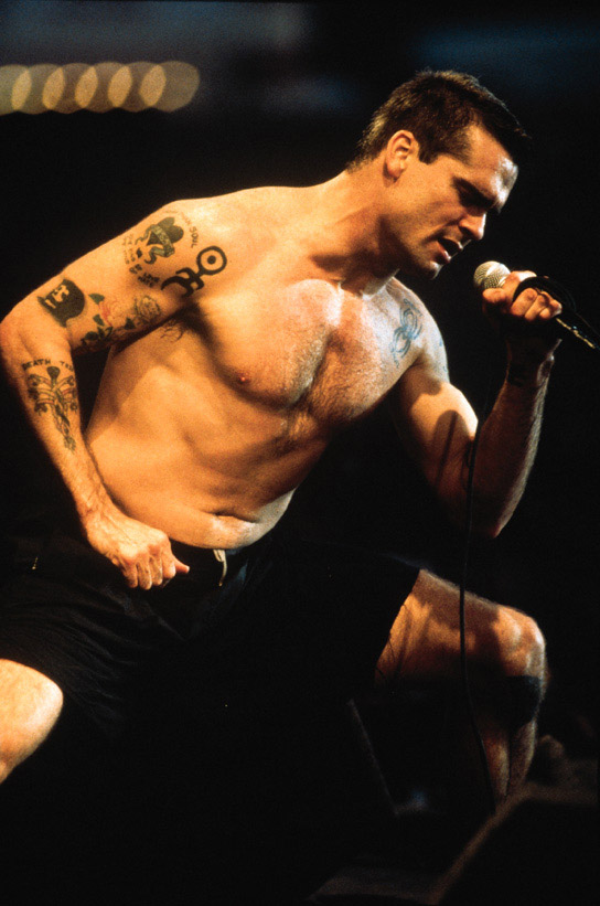huge photo of Henry Rollins, singing on stage shirtless