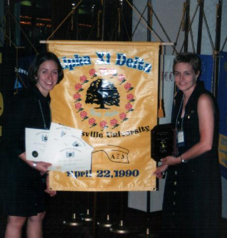Posing with the Theta Alpha Banner