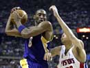 ... and puts his long arm out as Kobe shields the ball ...