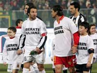 Juventus' captain Alessandro Del Piero, left, and Messina captain Antonio Di Napoli hand in hand with children who wear t-shirts reading 'Release Giuliana' in support of the Italian journalist Giuliana Sgrena kidnapped in Iraq.