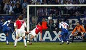 Players at Monaco's goalmouth watch as the Alberto's shot goes in