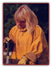 Female worker in rainclothes and rubber gloves