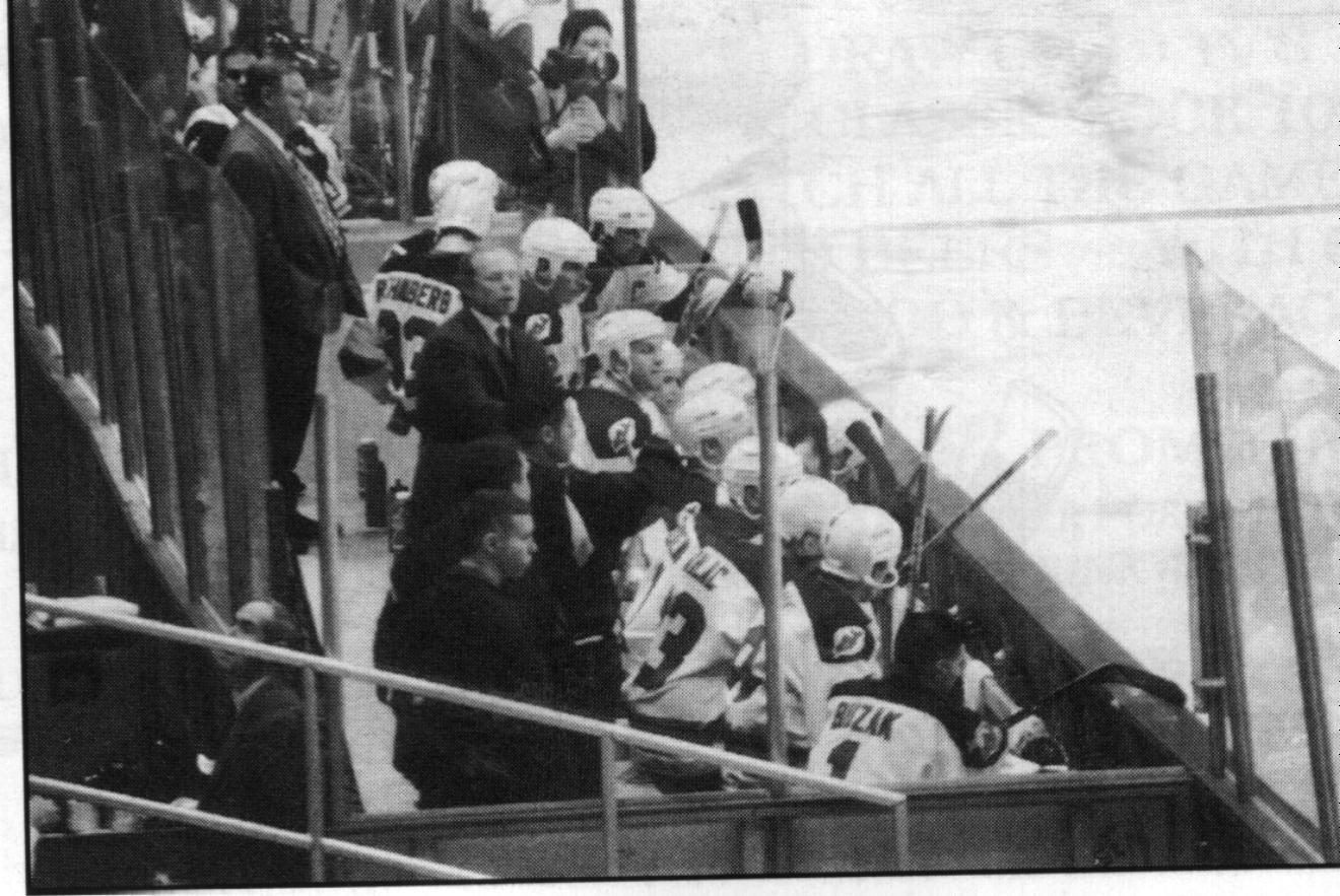 Some of the players and Coach on the bench last year.