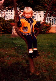 Krizia sitting on tree in Emanuele's garden