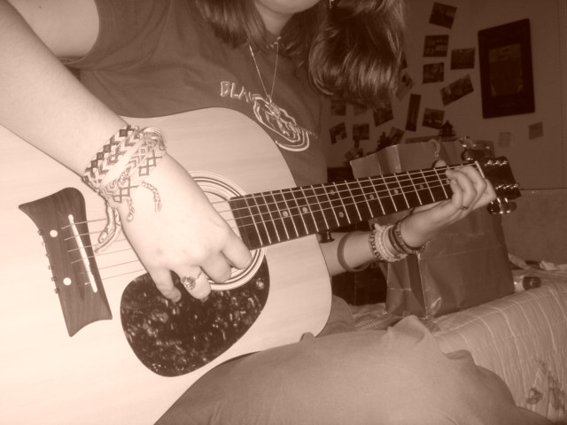 Sandy playing the guitar