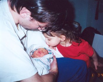 Joel holds Serena as Ariana looks on