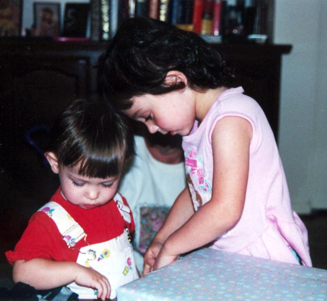Ariana helps Serena open a present