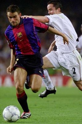 Overmars runs past Kelly.