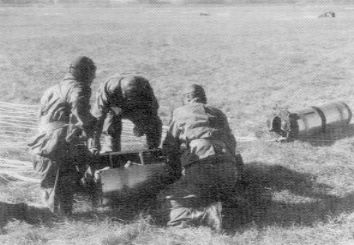 Japanese paratroopers recovering their weapons from equipment containers, Menado, January 1942