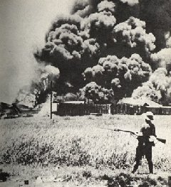 The oiltanks burning at Palembang, Sumatra Island in 1942