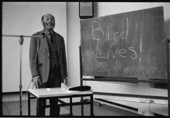Ted Joans writing BIRD LIVES in Hamburg