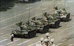 Colored photograph at Tiananmen square where a protestor stops tanks
