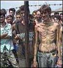 Coloured photograph of Bosnian Muslim and Croat prisoners held at the Keraterm concentration camp by the Bosnian Serbs