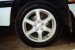 Here is the wheel before the front is jacked up to remove it. Remember to put the centre cap somewhere you can find it again, and always turn the wheel nuts enough to loosen them slightly when the vehicle's weight is still on the wheel. Jack the car, place chassis stands in a suitable location and remove the wheel nuts and wheel.