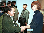 Kiyoshi shaking hands wih his fan