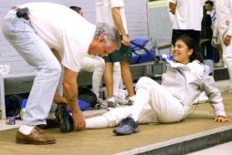 Photo of Ariana w/Epee coach Gene Davidson massaging the monster cramp