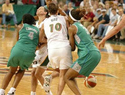 Sue Bird collides with other players