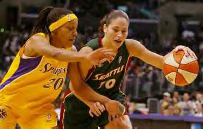 Sue Bird dribbles around Shaquala Williams during the second half