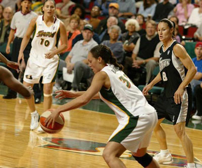 Sue Bird in the background while Adia has the ball in possession