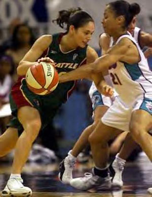 Sue Bird drives to the basket as Allison Feaster defends.