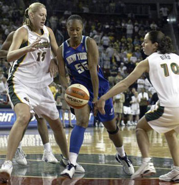 New York Liberty's Vivkie Johnson, center, has the ball slapped away by Sue Bird.