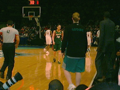 Sue is walking toward the bench