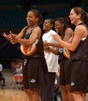 Tamecka Dixon, Sheryl Swoopes, Nikki Teasley, and Sue Bird cheer on their teammates during practice.