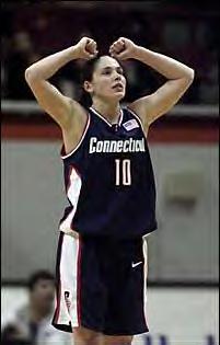 Sue Bird with her arms up in the air