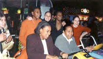 Sue Bird, coaches and teammates at an Arcade place