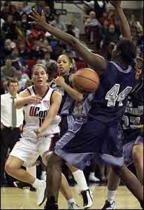 Sue Bird is trying a tough pass against  Lucienne Berhieu