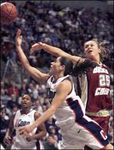 Sue Bird is trying to put in a lay up against Maureen Leahy