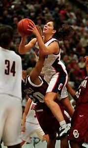 Sue Bird is trying to put in a lay up against  LaNeishea Caufield