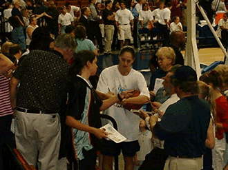 Sue Bird is signing autograph before the game