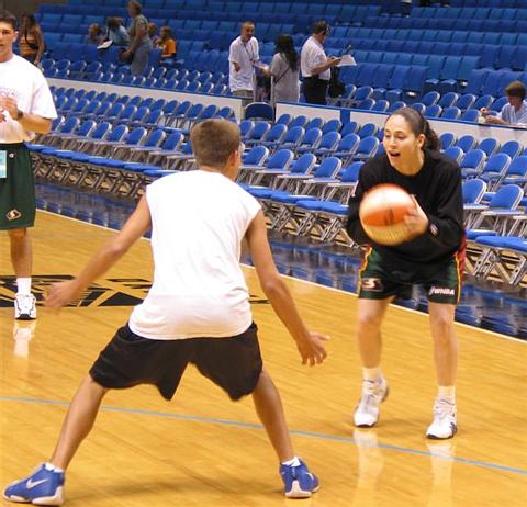Sue Bird playing one on one against a boy