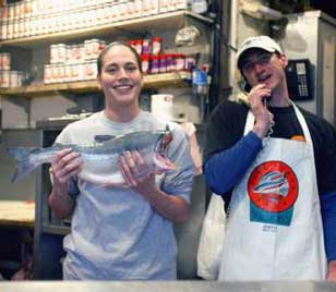 Sue Bird at fish market in Seattle