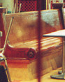 an old waiting room bench is in a snack bar downstairs