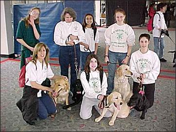 Puppy Raisers and Pups inside the airport terminal