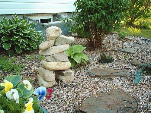 Inukshuk in perernnial bed