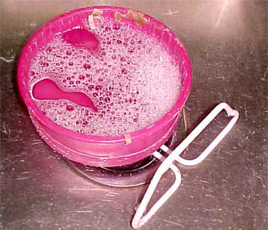 running wheel soaking in sink with soapy water