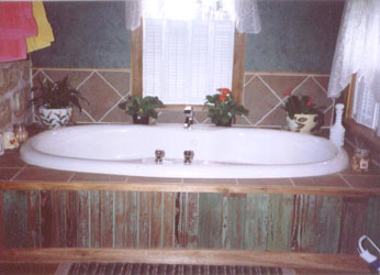Adjacent to the bedroom is the bath where you can enjoy a luxurious bath in the large whirlpool tub.
