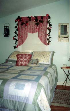 Another small bedroom offers a queen-size bed with lots of warmth. An old clawfoot tub with a shower is found in the bathroom. A telephone is available for your convenience. 