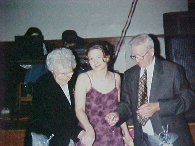 Mae Flynn, June-Ellen Wells and Bill Murray cutting the cake at the New Years Ball