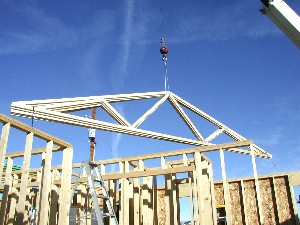 Crane lifts trusses into place