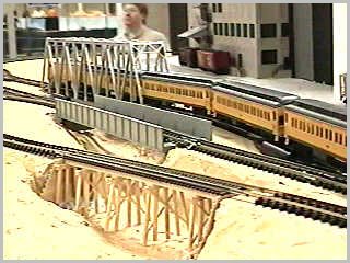 Passenger train through truss bridge