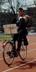 Setting the world record for playing the violin while riding a bicycle backwards