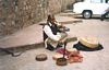 A snake charmer in Delhi. Do you see that snake on the left running away??